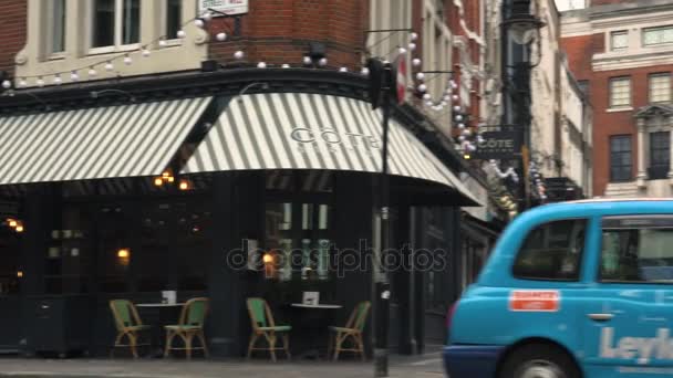 LONDON, UK - circa 2017: People at Soho area in London, UK. Different pubs and restaurants, tranquil scene of empty street and historical buildings, ultra hd4k, real time — Stock Video