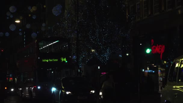 Londen - Dec 2016: Kerstverlichting en Londen bussen op het station op drukke Oxford Street London, England, Verenigd Koninkrijk in December, 2016. Oxford circus op verkeer rush. — Stockvideo