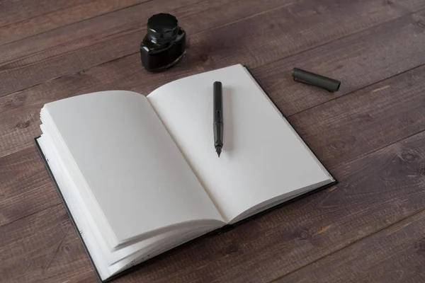 Fountain Pen, Notebook, Ink on wooden table — Stock Photo, Image