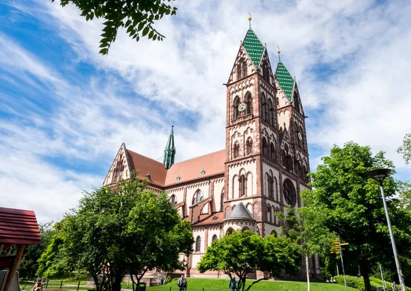 Herz-Jesu Church or Heart of Jesus surrounded by park for local activities in summer day.