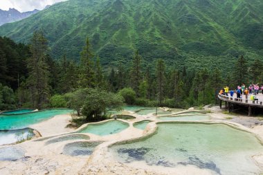 16 Temmuz 2017 - Sichuan, Çin: Seyahat eden personeli Konuklar hoş geldiniz gölet Huanglong parkta doğal nokta. İnsanlar inanılmaz doğal güzelliğiyle hayrete.