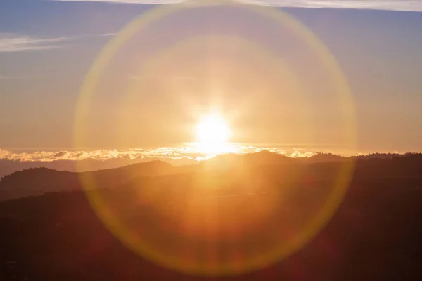 Beautiful sunrise with lens flare over the mountain