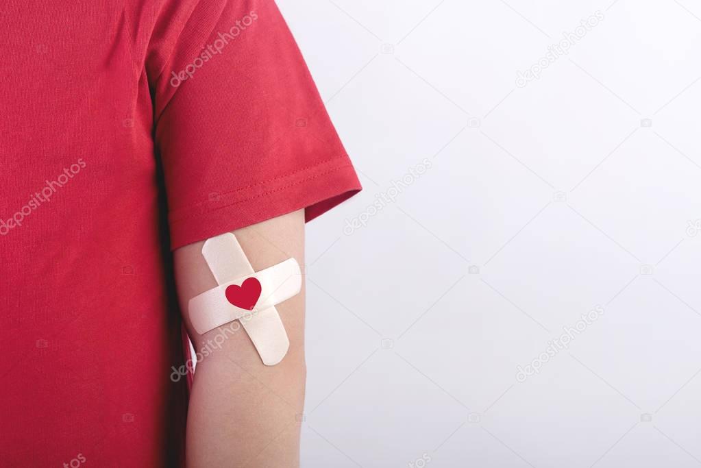 Child with a heart drawn on his arm. Blood donation concept