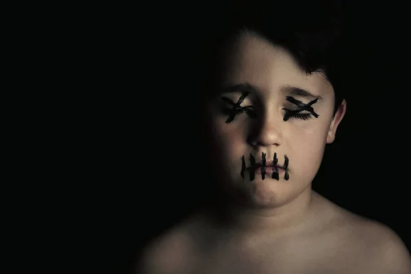 Child with painted face on black background — Stock Photo, Image