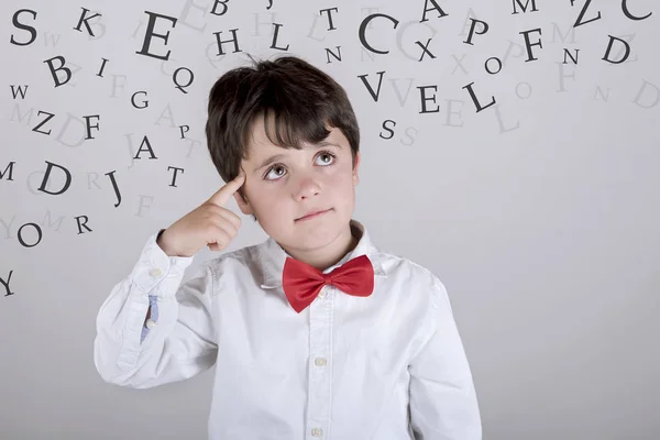 Alphabet. Composite image of thoughtful boy — Stock Photo, Image