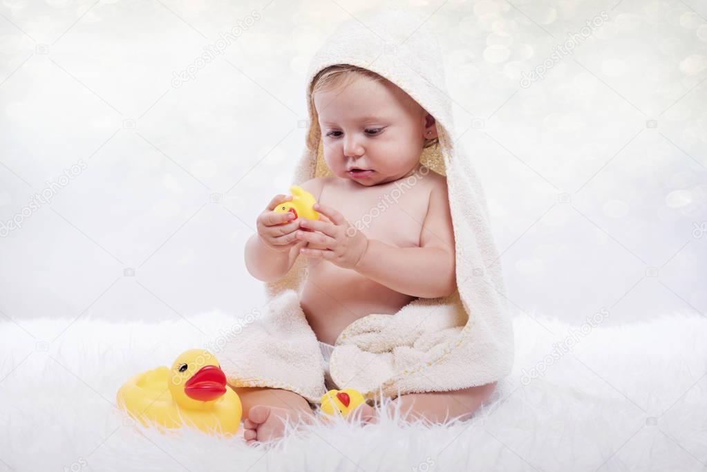 Happy baby in a towel, smiling baby in diaper