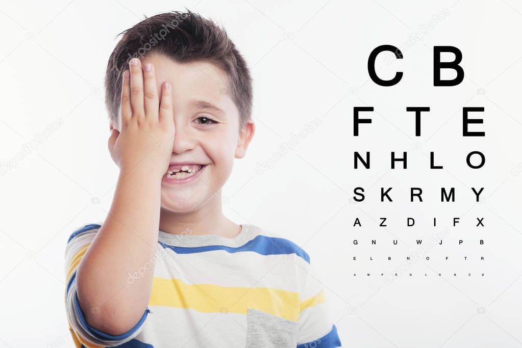 Boy at the optician, boy reviewing eyesight.