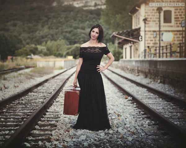 Young woman on train tracks