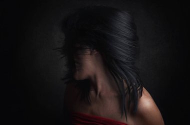 Woman with fear on black background clipart