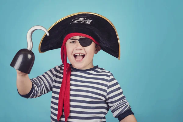 boy dressed as a pirate on blue background
