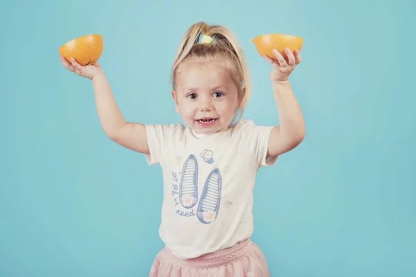 Baby Eating Orange Blue Background — Stock Photo, Image