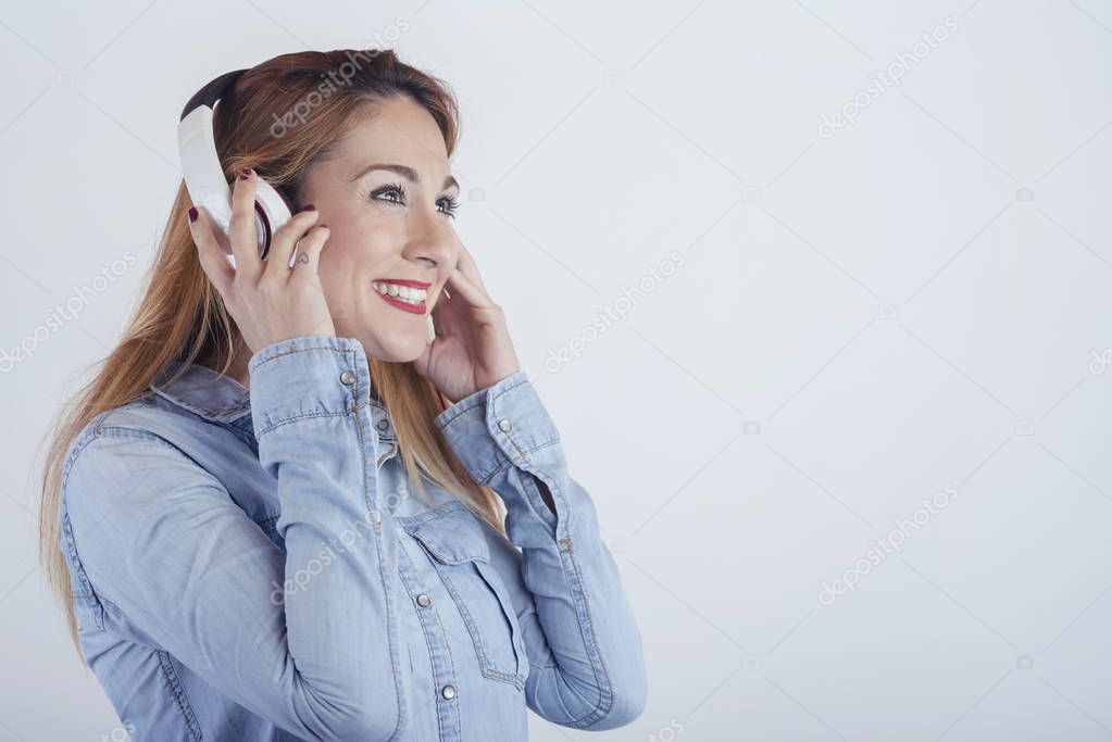 Happy young woman with headphones on white background