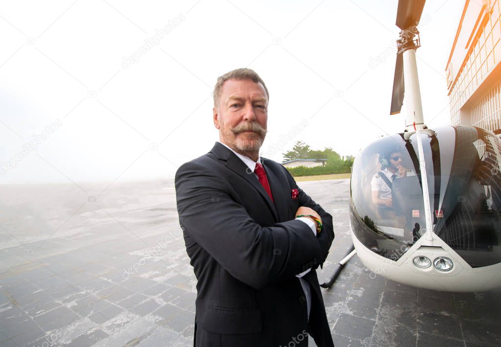 Business people traveling by helicopter , Shot of a mature busin