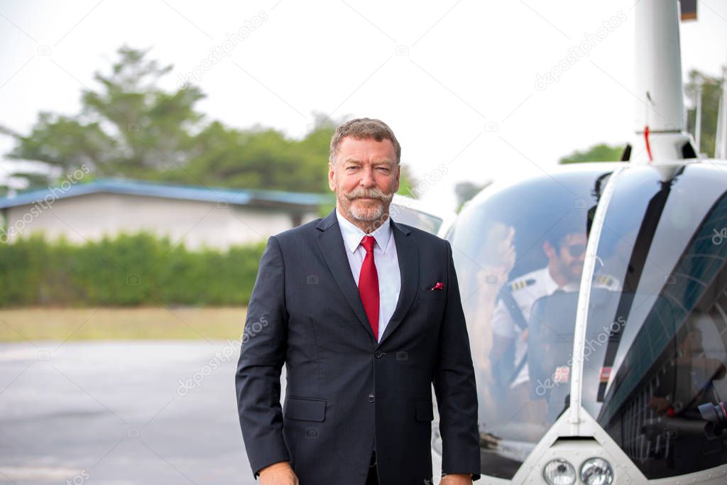 Business people traveling by helicopter , Shot of a mature busin