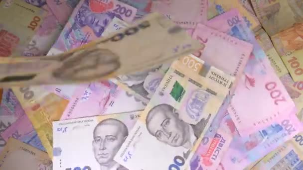 El dinero rota sobre la mesa. Denominaciones. Dólar y hryvnia — Vídeo de stock