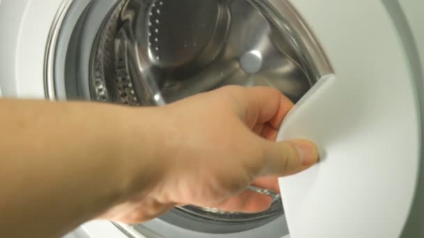 Men Loading The Laundry In The Washing Machine — Stock Video