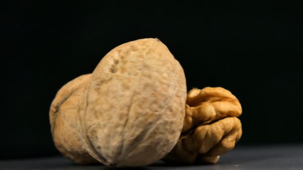 Walnuts nuts in rotation on black background. — Stock Video