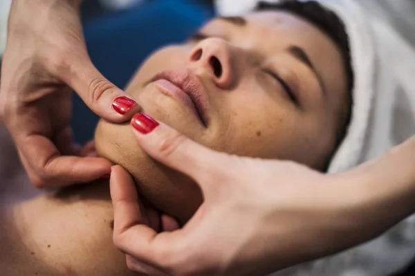 Ontspannende massage van het gezicht in een spa — Stockfoto