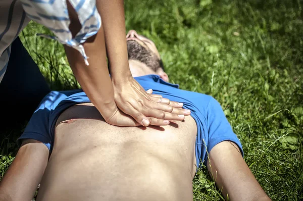 Cardiac massage to an unconscious guy after injury — Stock Photo, Image