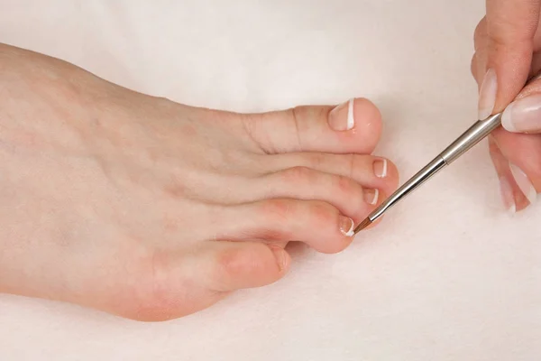 Doctor Podiatry removes calluses, corns and treats ingrown nail. Hardware manicure. Concept body care.