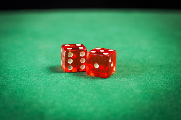 red dice over green surface image close up