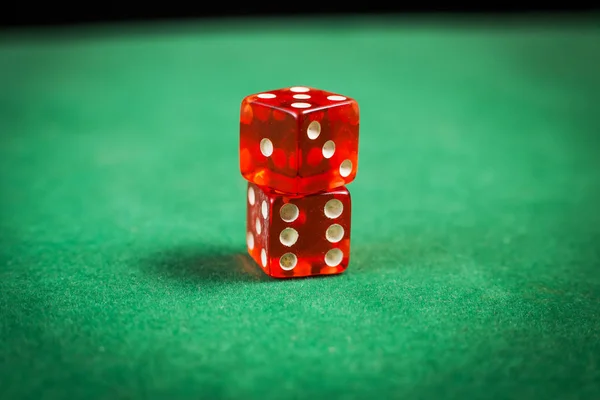 Red dice over green surface image close up — Stock Photo, Image