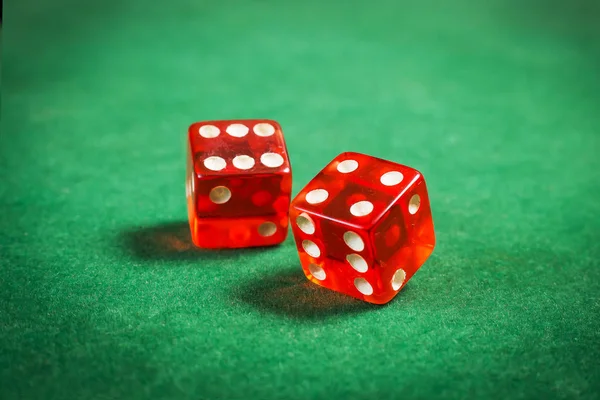 Red dice over green surface image close up — Stock Photo, Image