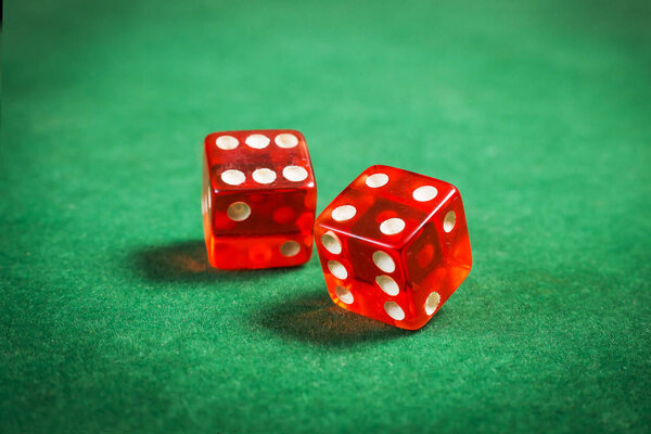 red dice over green surface image close up