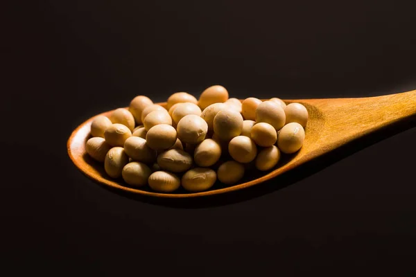 Soy beans  on wood spoon — Stock Photo, Image