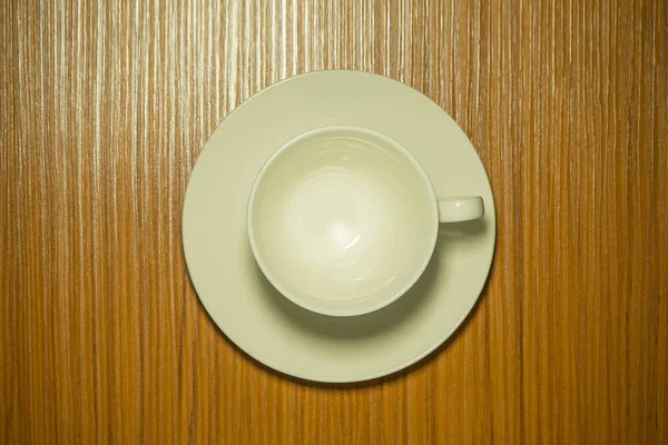 Біла чашка кави на дерев'яному столі вид зверху — стокове фото