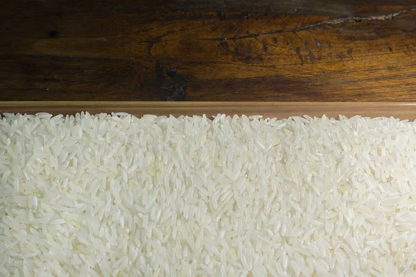 Rice grain  on wood table image for background. — Stock Photo, Image