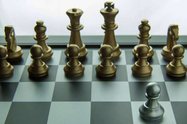 The gold and silver chess on board close up image abstract Background.