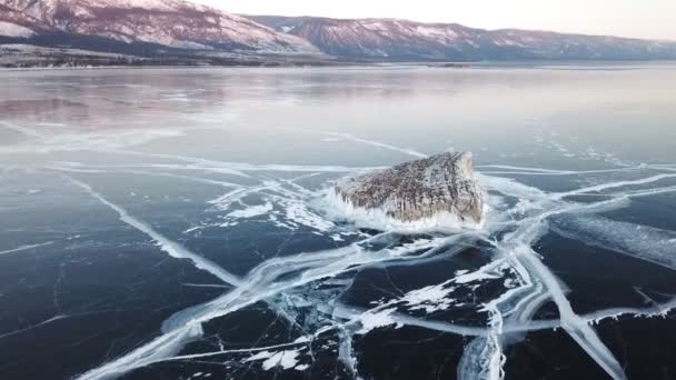 Vista aerea sul lago Baikal. Lago invernale con bellissimo ghiaccio. Rocce sulla costa e sulle isole. Inverno russo. Colpo di droni . — Video Stock