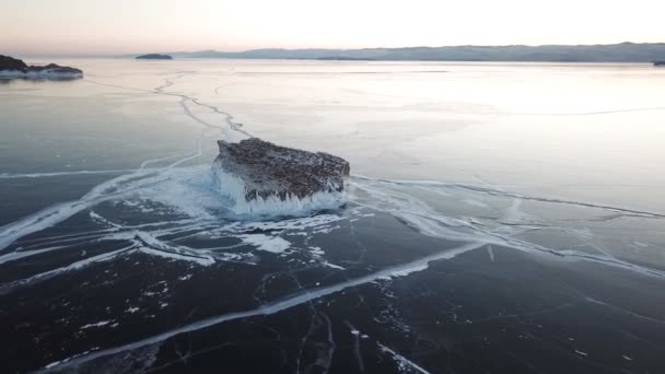 Vista aerea sul lago Baikal. Lago invernale con bellissimo ghiaccio. Rocce sulla costa e sulle isole. Inverno russo. Colpo di droni . — Video Stock