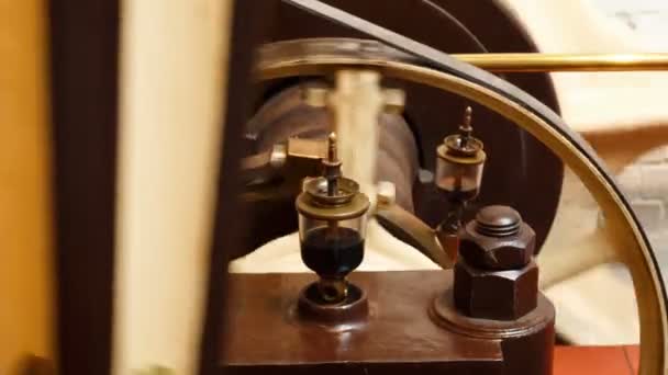 Closeup view of a flywheel of a single cylinder industrial steam engine in operation — Stock Video