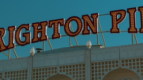 Ultra vista de primer plano de las letras vintage y la bandera Union Jack en la entrada del muelle de Brighton, Inglaterra, Reino Unido — Vídeo de stock