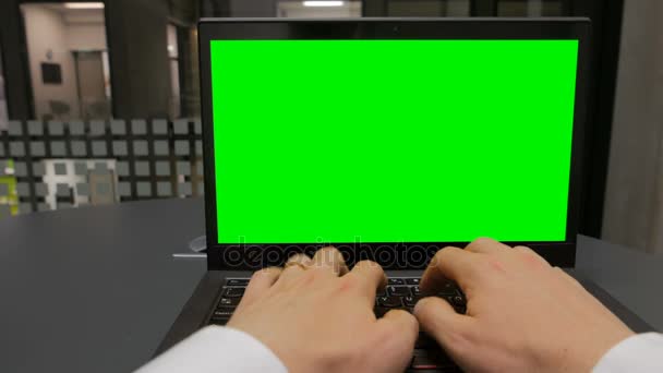 Tiro POV de um trabalhador de escritório digitando em um laptop com tela verde chave chroma incluído — Vídeo de Stock