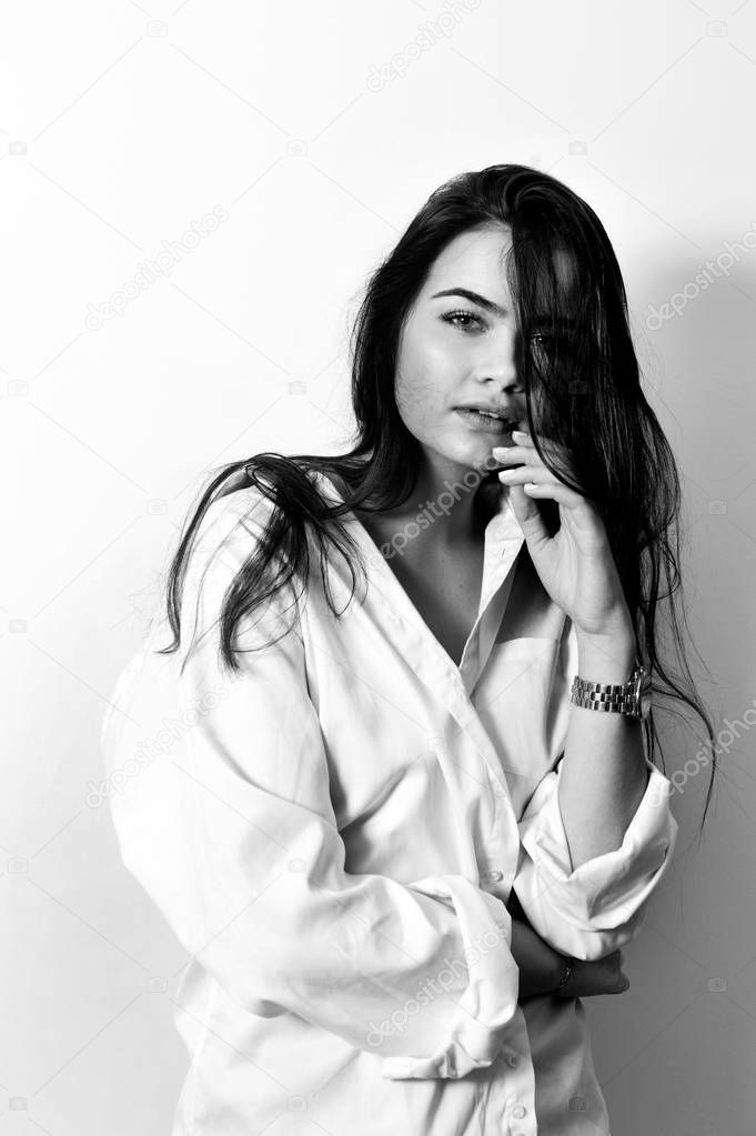 Young European attractive sensual fashion model is posing in white shirt