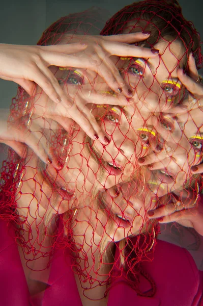 sexy woman with bright pink clothes, pink nets on head Conceptual color photography in kaleidoscope.. Fashion style