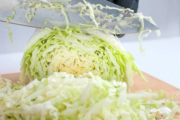 Slicing vegetables, cabbage on the board — Stock Photo, Image