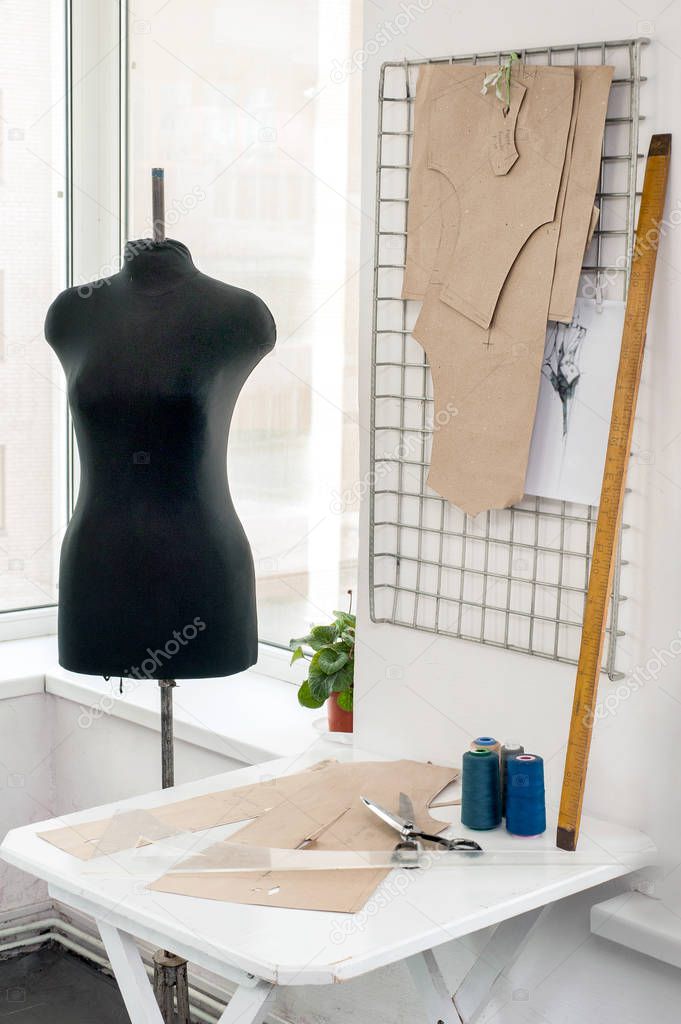 couturier workplace with mannequin, , sewing equipment, patterns, sewing studio with clothes hangers