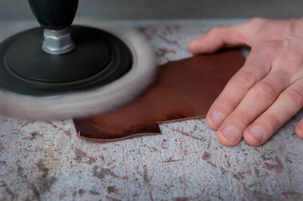 Close up, the master work with grinding of leather products — Stock Photo, Image