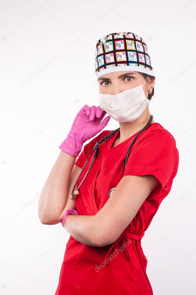 Female attractive doctor with mask and stethoscope standing on white background