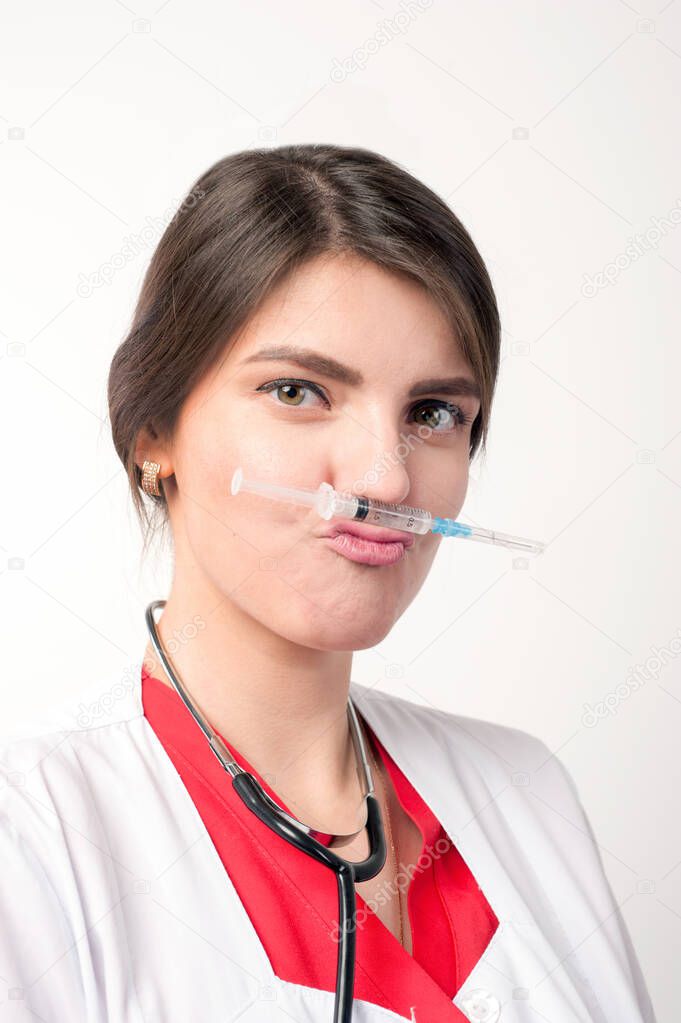 funny portrait of medical worker joking with syringe