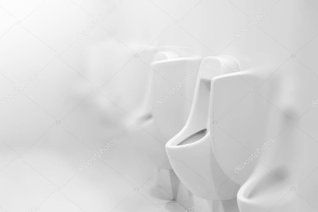 Urinals in white public toilet or restroom, interior design, mal