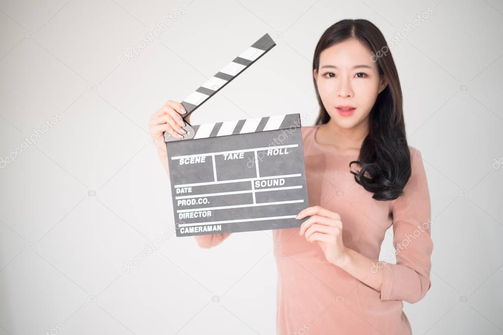 sian woman holding movie clapper board isolated on white backgro