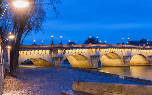 The Pont Neuf New Bridge and Seine river at night , Paris, France.