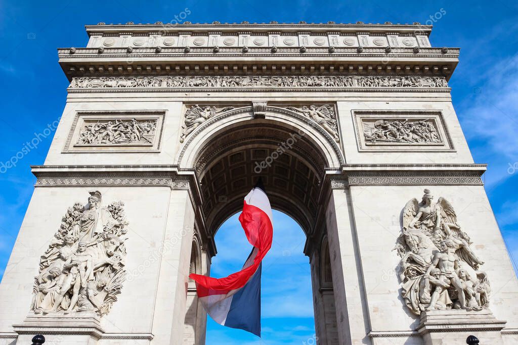 The Triumphal Arch decorated with National French flag, Paris, France.