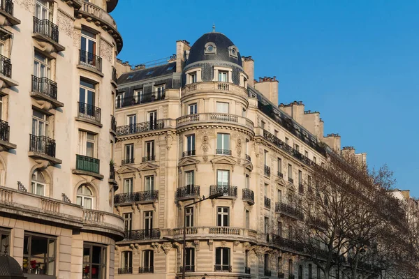 Traditional French house with typical balconies and windows. Paris, France.