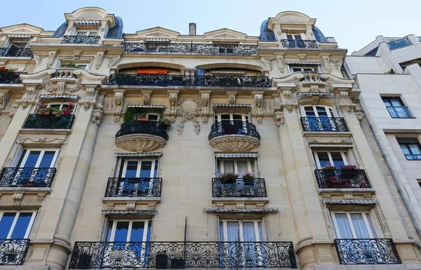 Traditional French house with typical balconies and windows. Paris, France.